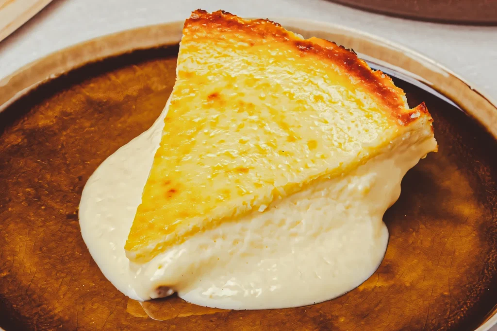 Melted lava‑style cheesecake slice with a golden baked top and soft, flowing creamy center, served on a rustic plate for an indulgent dessert presentation