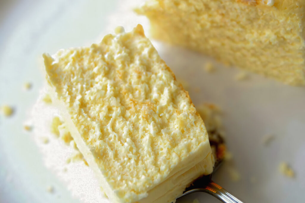Detailed close‑up of a fluffy, airy cheesecake slice showing its soft, whipped texture