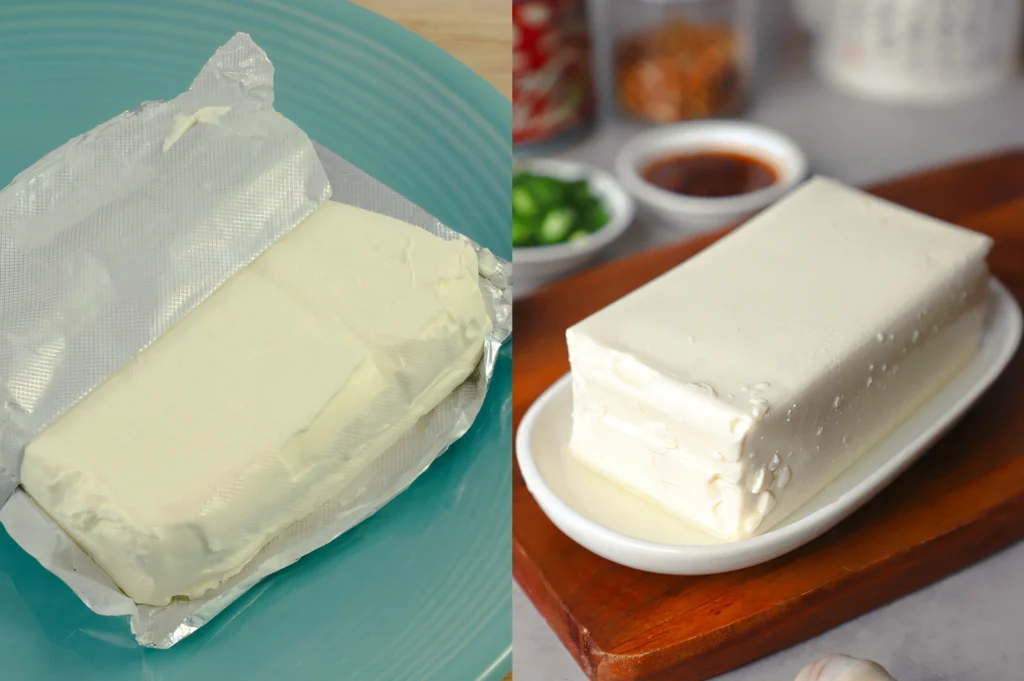 Eye‑level close‑up shot comparing two white blocks, with cream cheese on the left on a blue plate and silken tofu on the right placed on a wooden board, highlighting similar appearance and smooth texture for dairy versus plant‑based comparison.