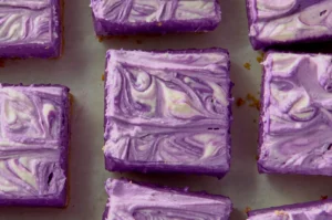 Purple swirled dessert bars arranged on a surface.
